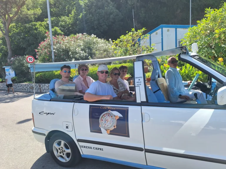 Group of tourists smiling on a golf cart in Capri
