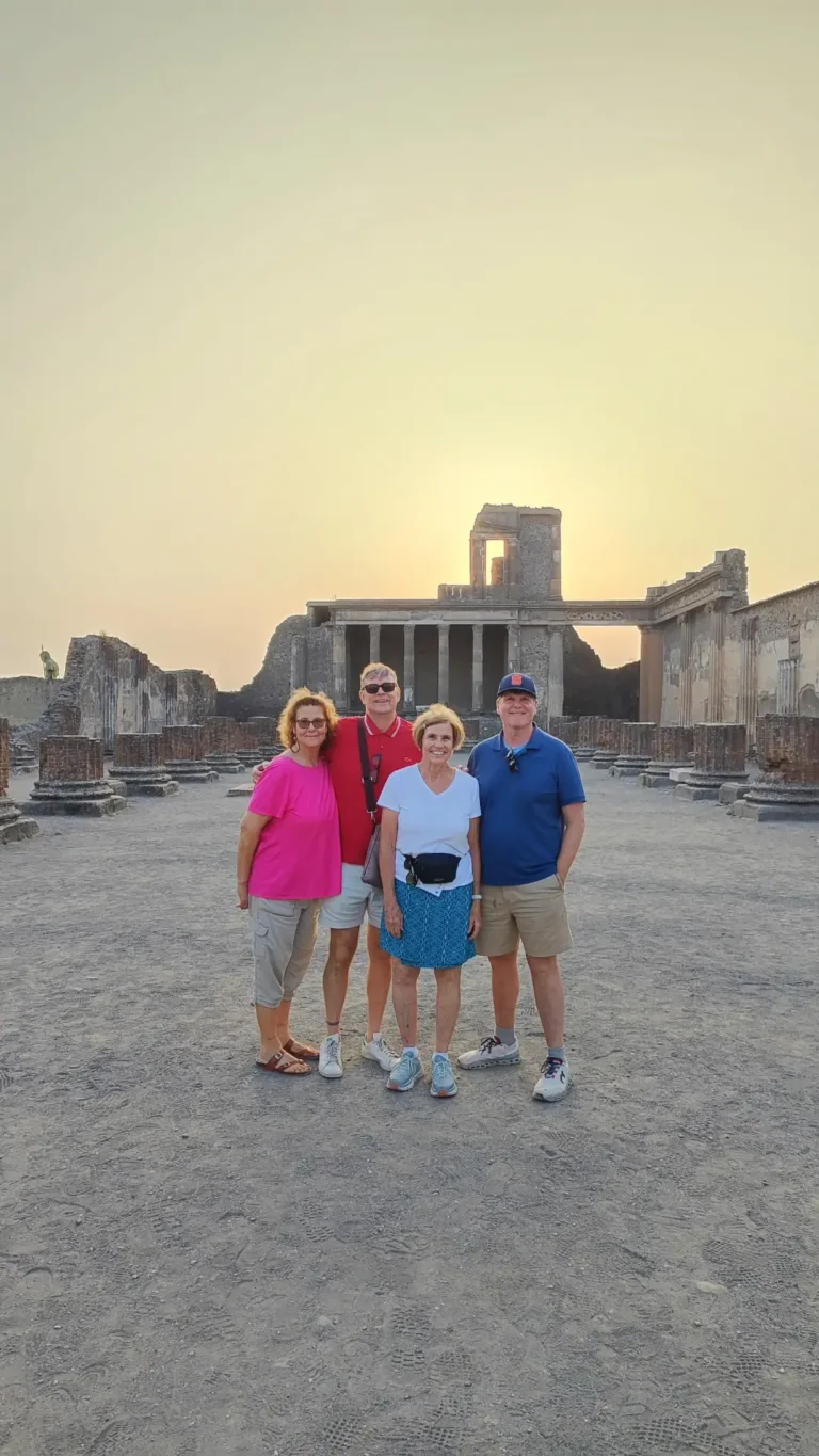 A group of tourists smiling during their tour in Pompeii